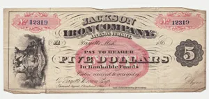A vintage five-dollar paper note issued by the Jackson Iron Company in Fayette, Michigan, featuring pink decorative accents, serial number 12319, and a dark number 5 seal on the right.