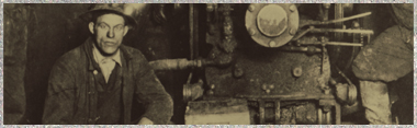 UP miner kneeling near steam engine circa late 1800's.